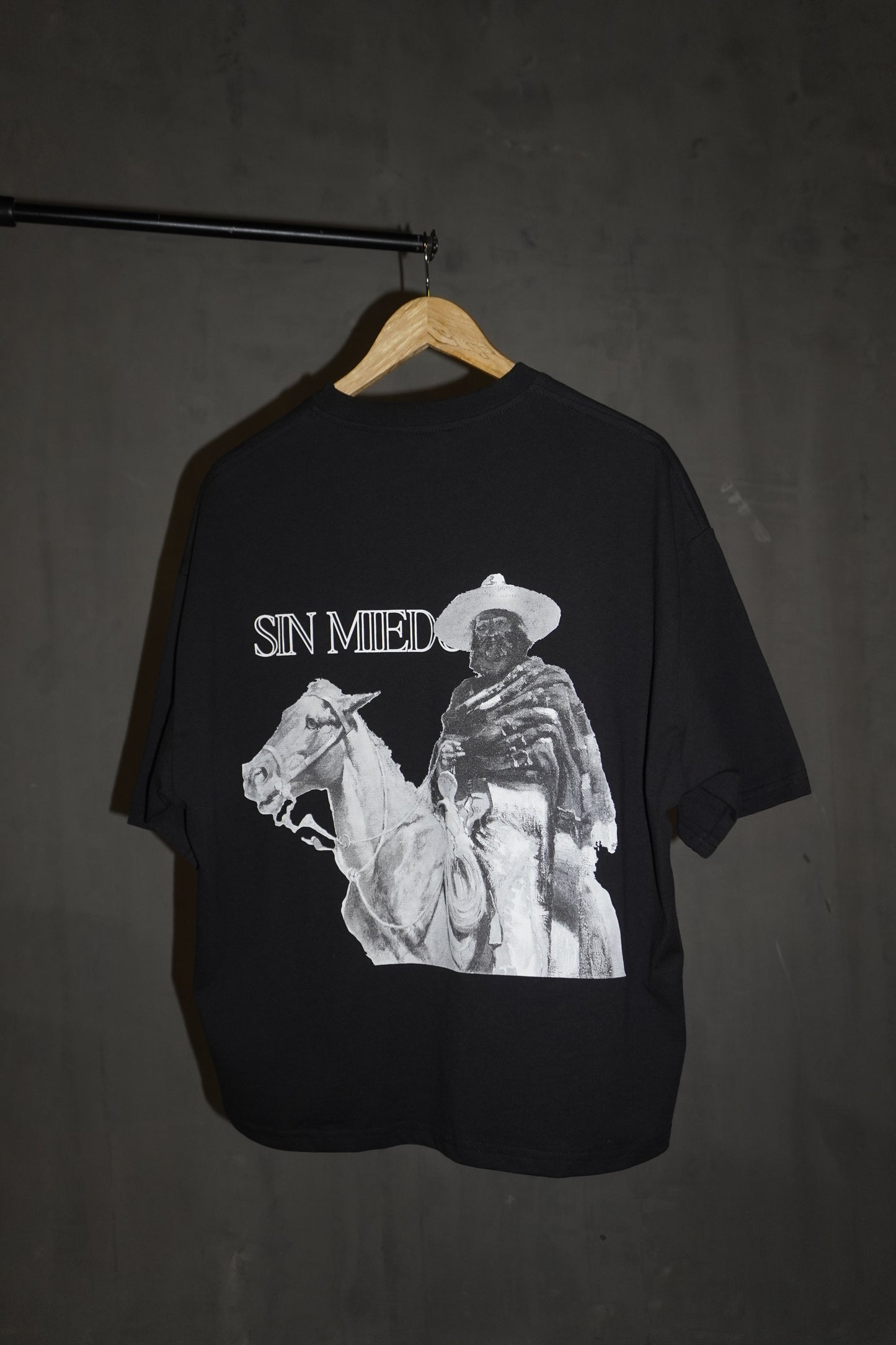 durable cropped fit black tee with white and grey tones accenting the original cowboy graphic